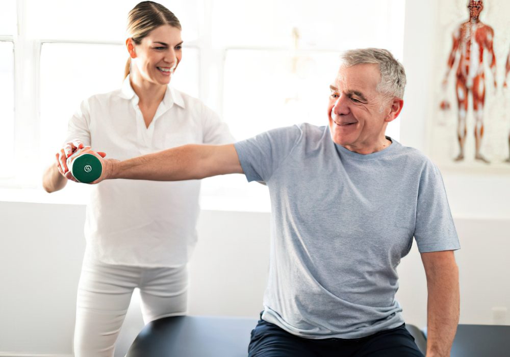 Modern rehabilitation physiotherapy worker with senior client